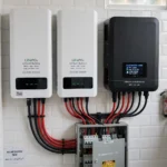 Wall-mounted lithium batteries installed beside a hybrid solar inverter in a Pakistani home